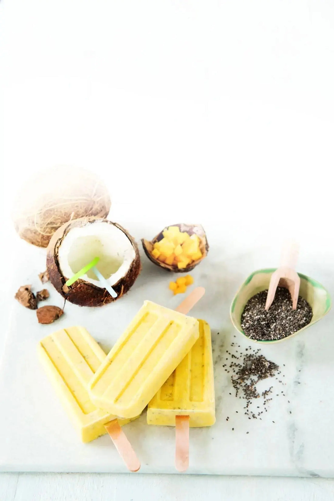 Mango-Kokos-Eis mit Chiasaat, garniert mit frischer Mango, Kokosraspeln und Chiasamen