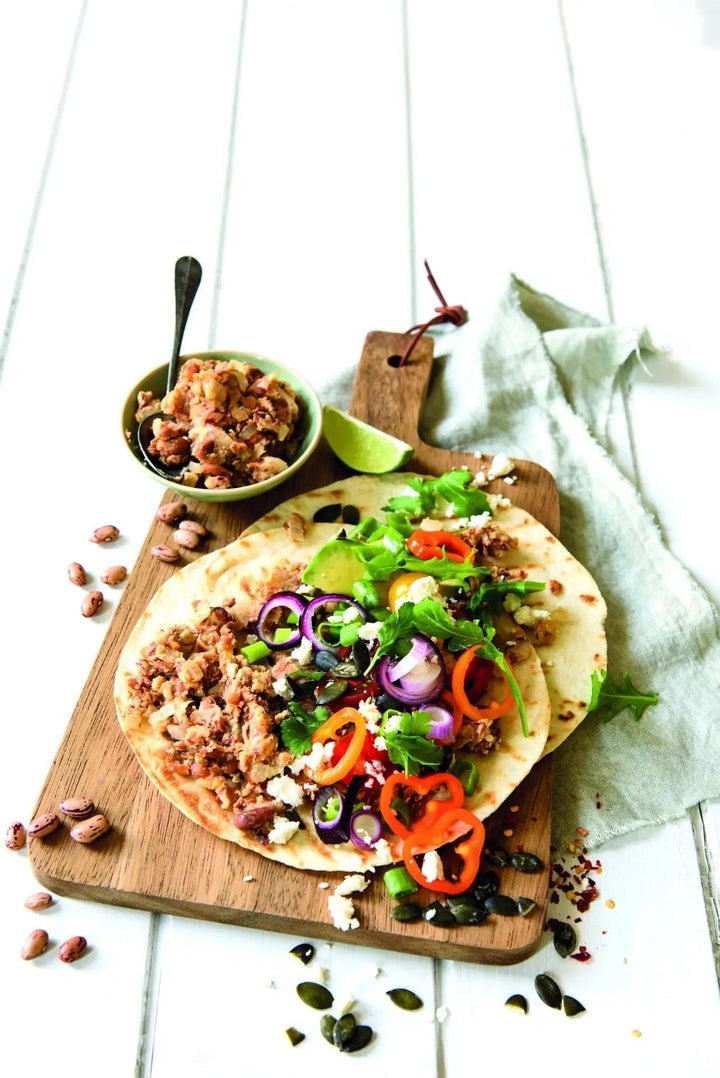 Tex-Mex-Tortillas mit Wachtelbohnen und buntem Gemüse, gefüllt und gerollt, mit frischen Zutaten
